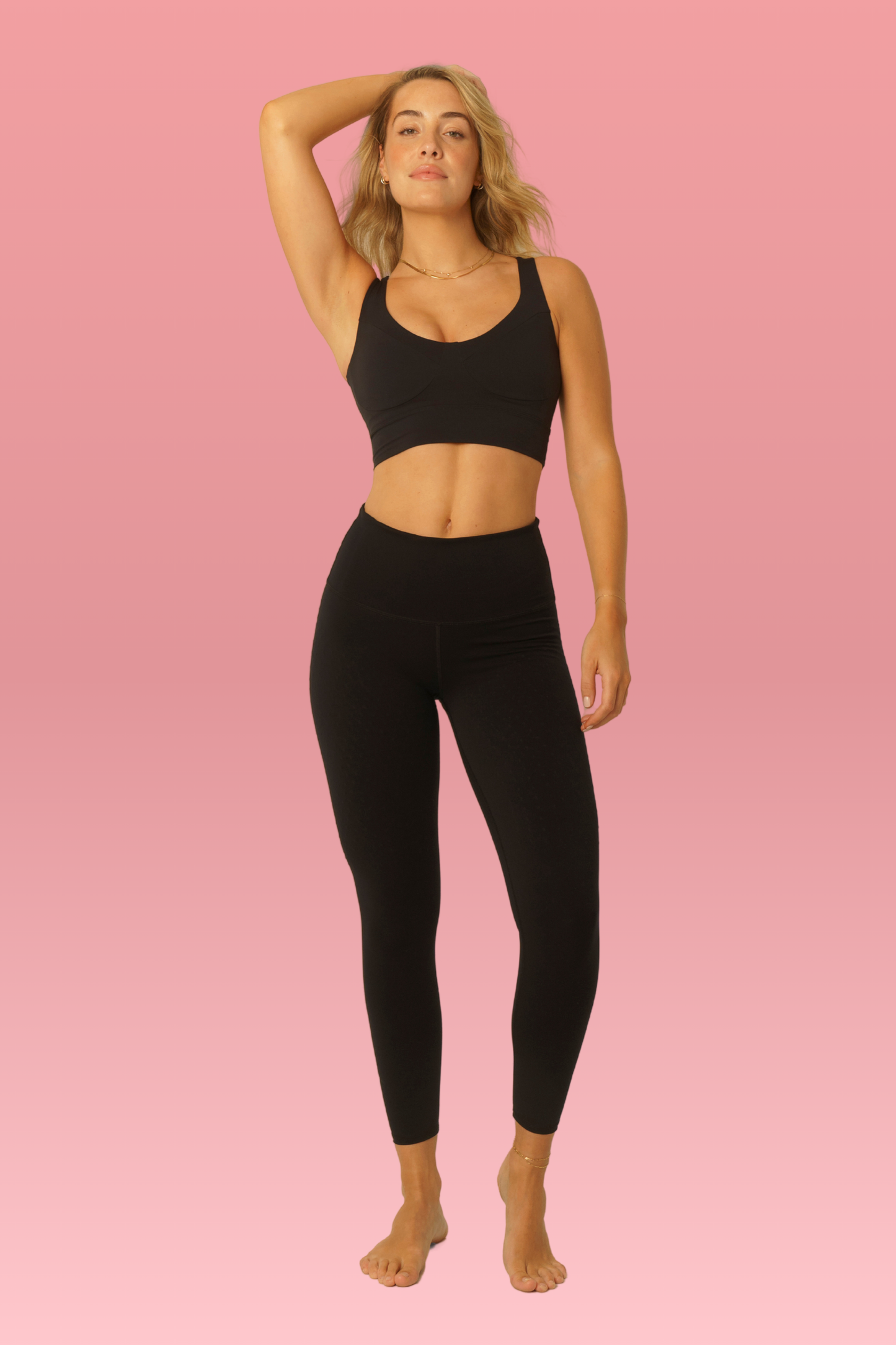 Model wearing L'Original 25'' leggings in black with pink logo to support breast cancer thrivers