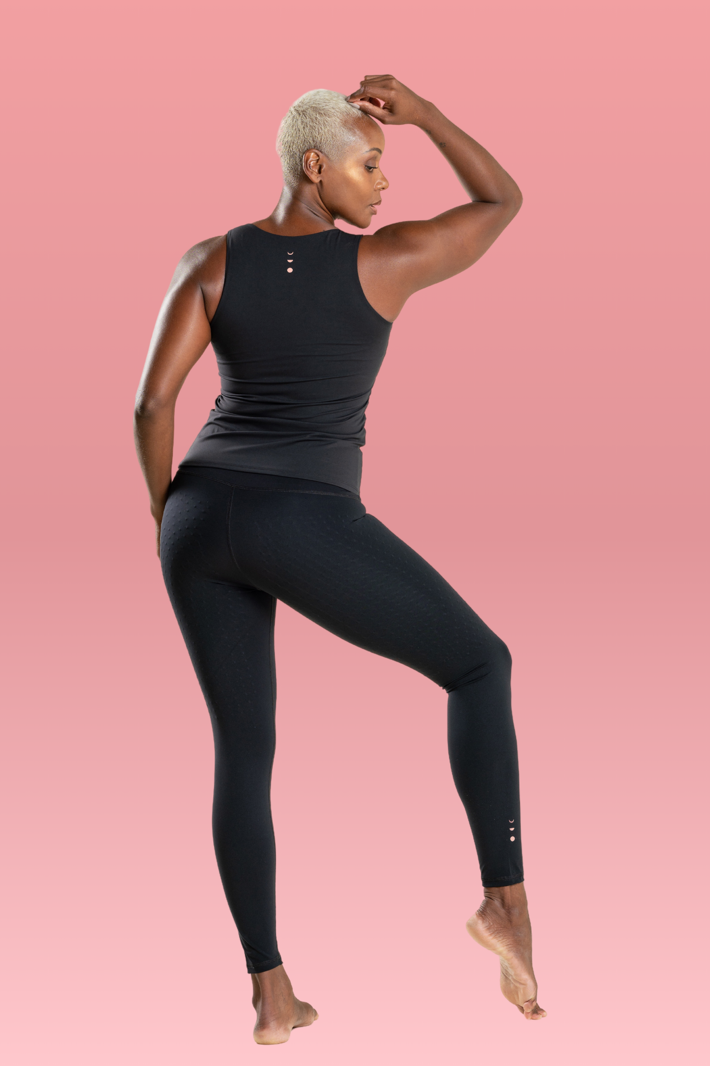 Model wearing L'Original 25'' leggings in black with pink logo to support breast cancer thrivers